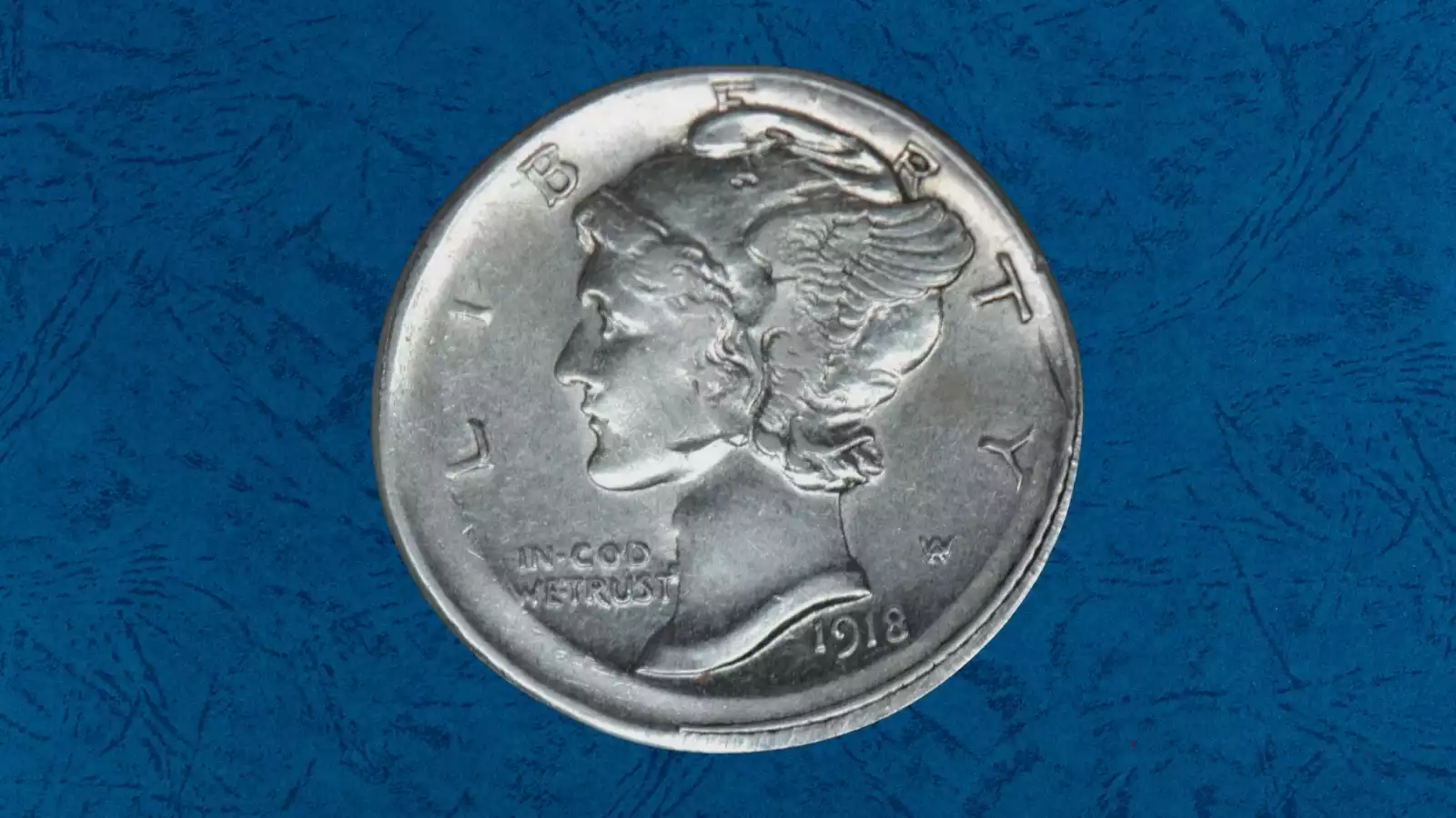1918 Mercury dime off-center strike showing blank planchet crescent with shifted Liberty portrait, date still visible
