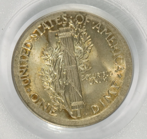 1918 Mercury dime struck on wrong copper planchet showing copper color instead of silver, placed next to a normal silver dime for comparison